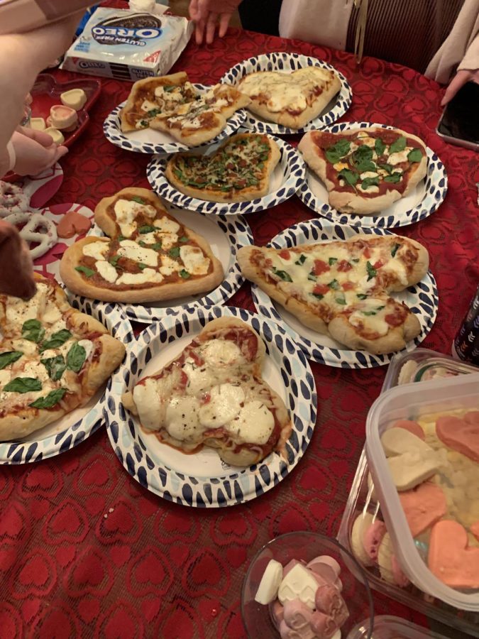 On Valentines Day weekend, a group of WCHS sophomores craft heart-shaped personal pizzas to celebrate their appreciation for one another in a heart-themed gathering.