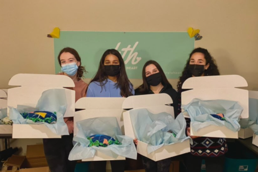 Volunteering outside of school with Kits to Heart, Mary Stockschaleder, Anjali George, Lauren Turner, and Julie Nustray package care kits with various goods for cancer patients on November 12.