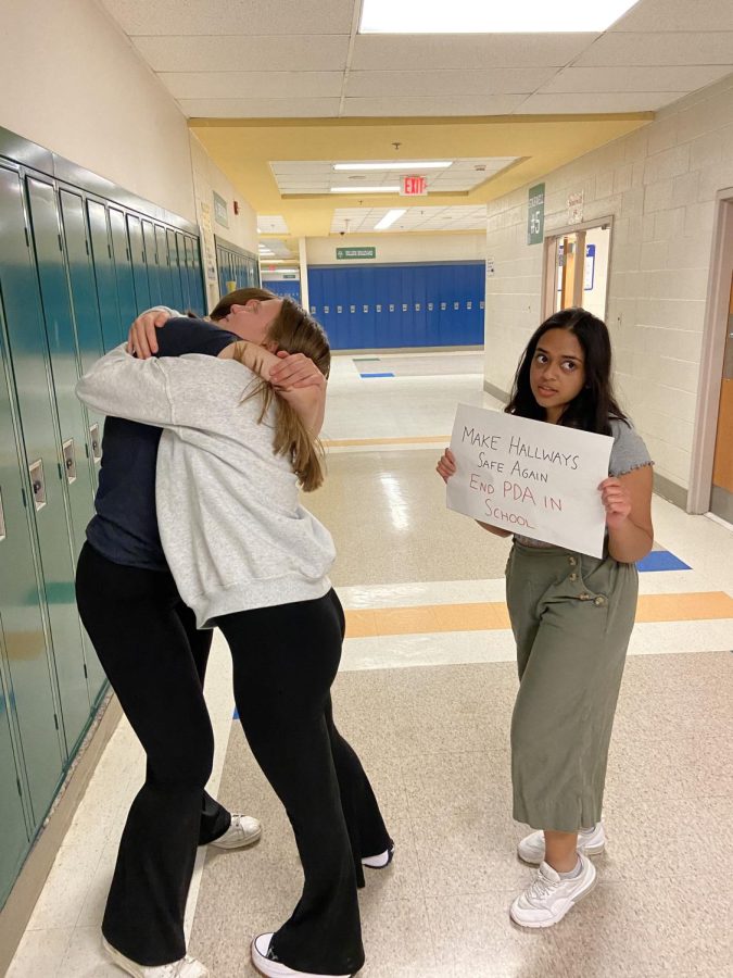 A concerned student protests a couples display of affection in the hallway.