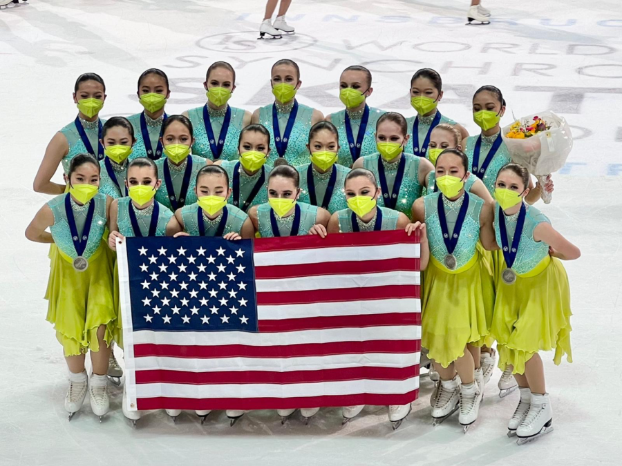 Smiling with her Skyliners synchronized skating team, senior Samantha Handrigan poses for a picture after winning the silver medal at the Junior Synchronized Skating World Championships