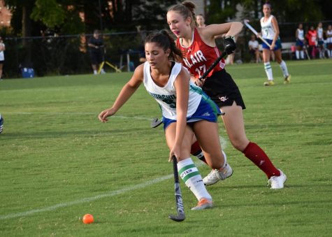 Senior field hockey captain Jordan Lapidus corrals a wild pass in the corner of the field while attacking the goal in a game against Blair during the season opener.