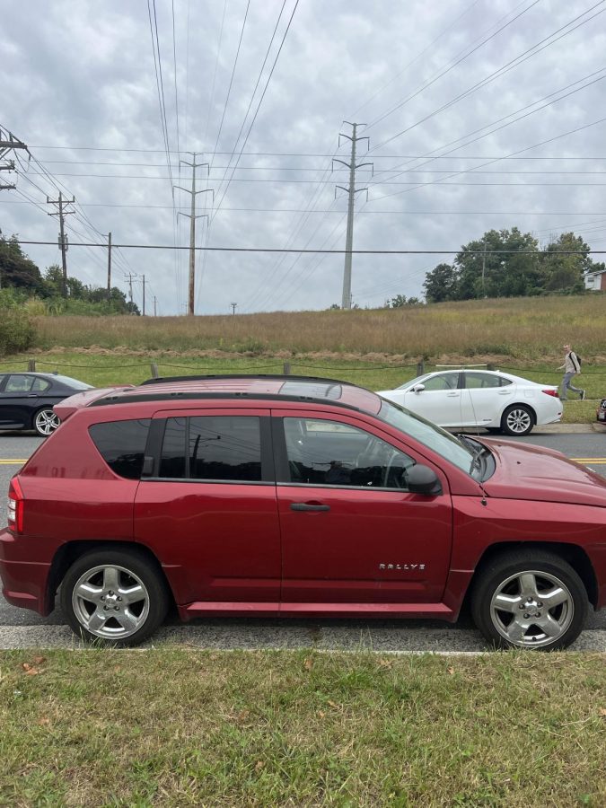 The car of a WCHS student is parked legally in front of power lines. The power line field is a trek for students from school.