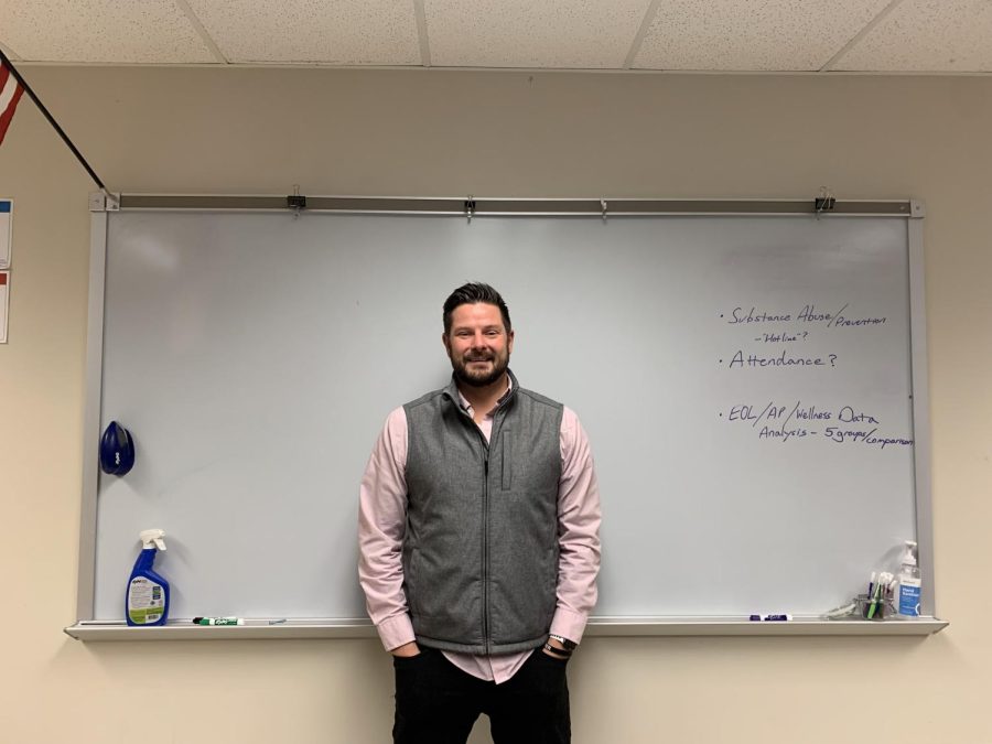 WCHS principal intern, Patrick Bilock, stands in the middle of the administration meeting room on Oct. 28, 2022. Bilock is projected to fill Principal Taylors position before the end of 2022 .