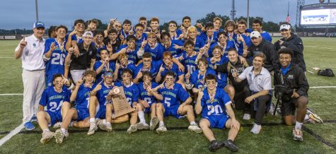 The WCHS boys lacrosse team poses with the trophy after winning the 2022 Maryland state championship. 