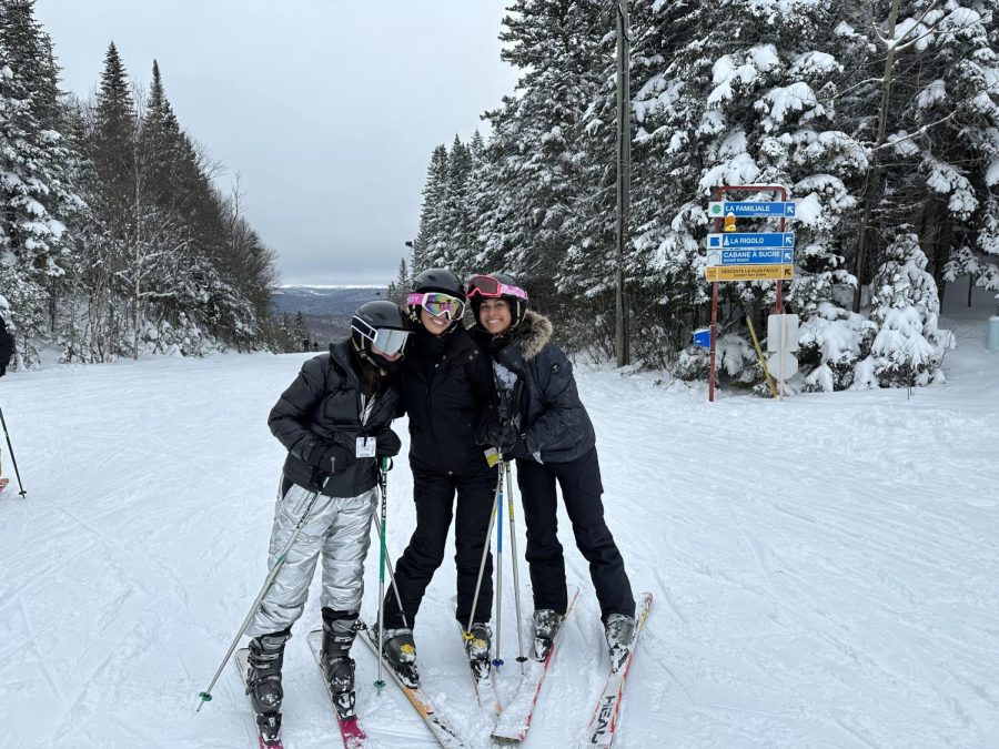 Noa Assouline poses with friends at the top of a ski slope during the senior ski trip before taking a run down to the bottom of the mountain.