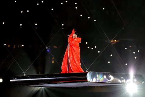Rhianna is lifted into the air on a glass platform while performing her hit “Shine Bright Like A Diamond” in her futuristic red costume during her halftime performance on Feb. 12