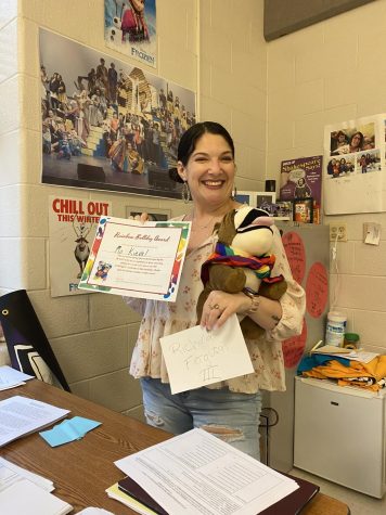 Ms. Keival posing with her Rainbow Bulldog Award that she was presented to by the GSA for taking the extra steps in making her classroom a safe and inclusive environment.