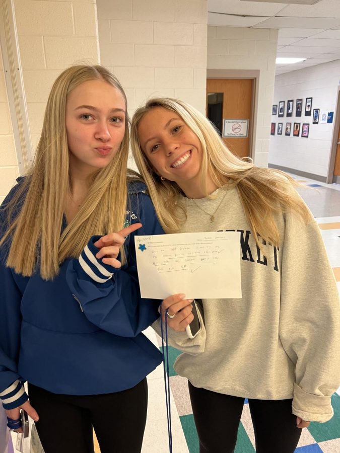 Sophomores Juliet Will (left) and Justina Gumucia (right) smile while appreciating a sticker that a teacher left on a quiz that was completed successfully.