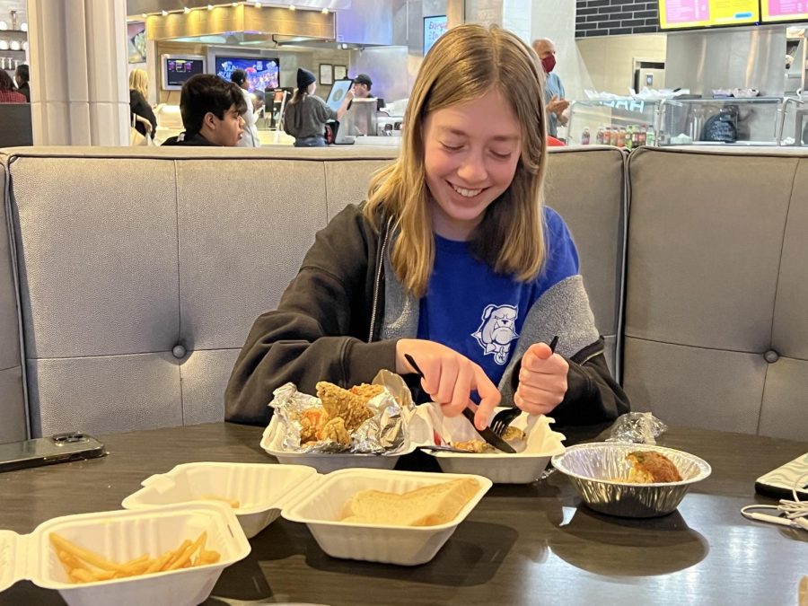 WCHS sophomore Blythe Cook enjoys a plate of fried fish with a side of collard greens for the first time as she appericiates soul food at Malias Kitchen located between Mcdonalds and Philly Cheesesteaks. 