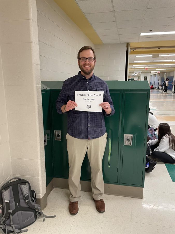 Mr. Freundel, shown holding up his Teacher of the Month certificate, teaches both AP Psychology and Honors World. 