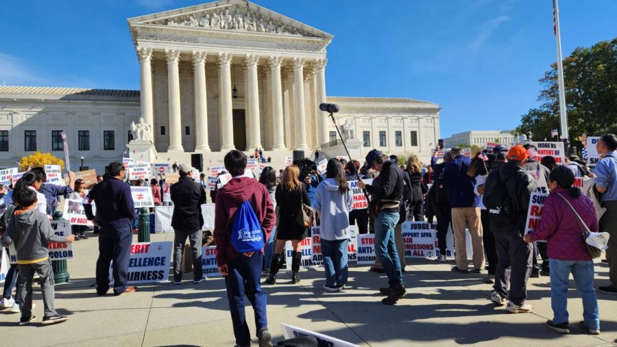 Protestors stand outside the Supreme Court on Oct. 30, a day before the beginning of arguments regarding the status of affirmative action at U.S. colleges.