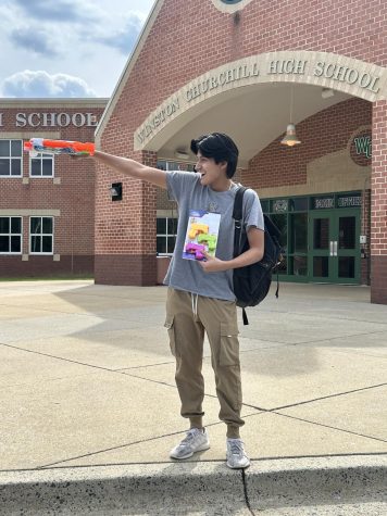 Senior Vincent Leon stands outside the WCHS Main Entrance with his water guns that he bought from Target. 