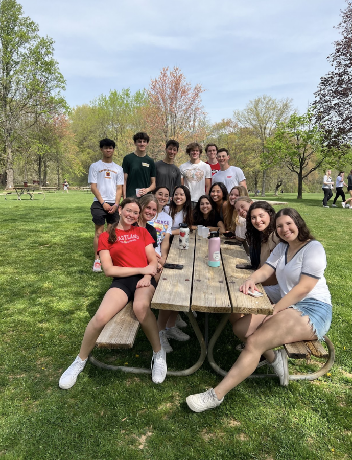 Seniors+gather+around+a+table+together+hanging+out+at+Senior+Day+on+April+14.+Senior+Day+consisted+of+many+games%2C+sports%2C+food+and+drinks+for+all+seniors.