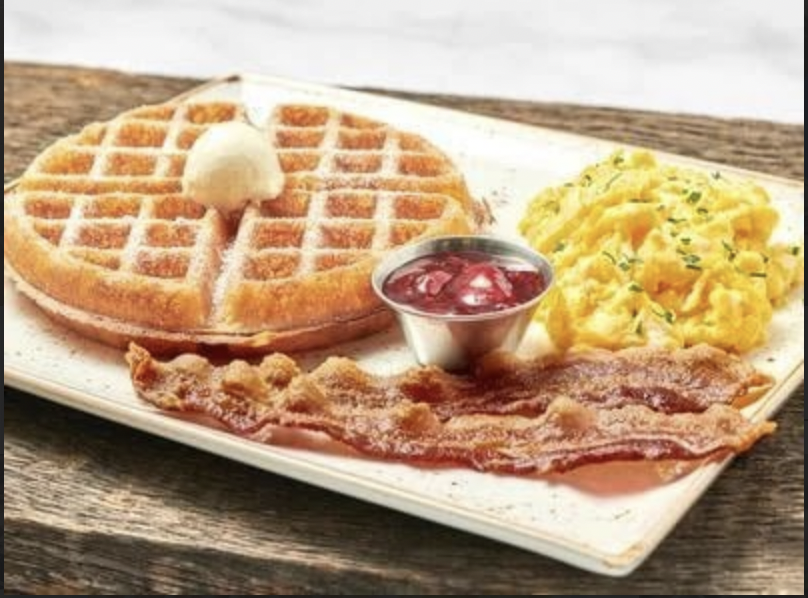 The popular Tri-Fecta dish includes a generous portion of waffles, eggs, and bacon. It is one of First Watchs most classic favorites that families like to delight in to start their day off right.