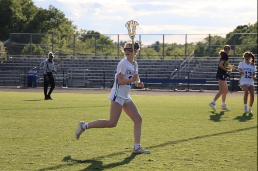 Ella+Carnathan%2C+a+freshman+on+the+WCHS+Girls+Varsity+Lacrosse+team%2C+receives+the+ball+and+pivots+to+carry+it+up+field+toward+the+goal.