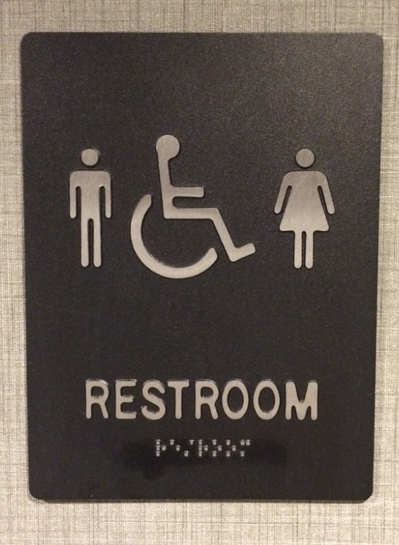 A gender-neutral bathroom sign is posted in order to allow people who dont identify specifically as male or female.