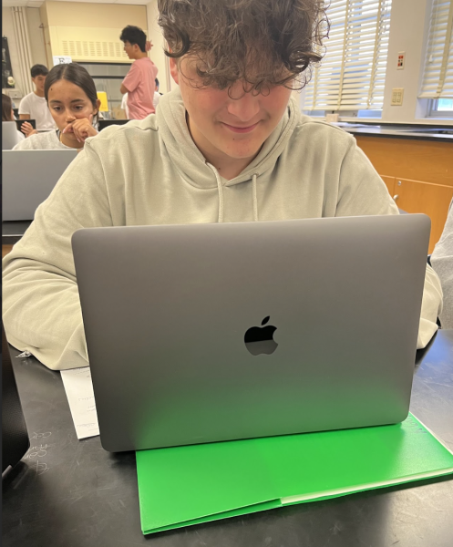 WCHS senior Eric Bomfim using his MacBook during class to complete assignments. The continual use of personal laptops is something WCHS is trying to eliminate. 