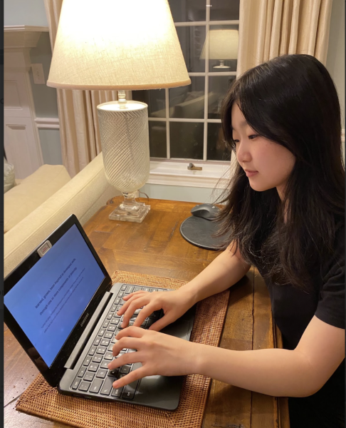 Typing on her computer, WCHS senior Jaehee Lee drafts ideas for a diversity prompted supplemental essay on Oct. 1 2023.  