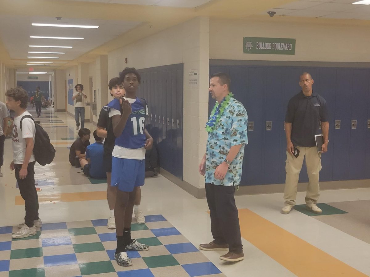 WCHS administration, security and students take in the aftermath of an incident in which one student jokingly slammed a cake into another students face.