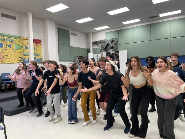 The WCHS Mama Mia cast is all smiles when rehearsing their last number, Mama Mia, before they take their final bows. 