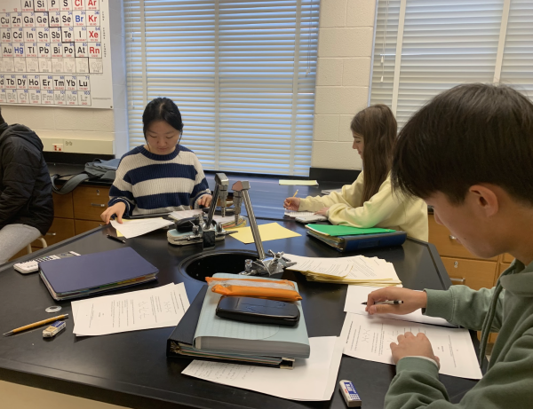AP Chemistry students are grouped into lab tables where they are expected to collaborate on solving the problems and helping each other learn.