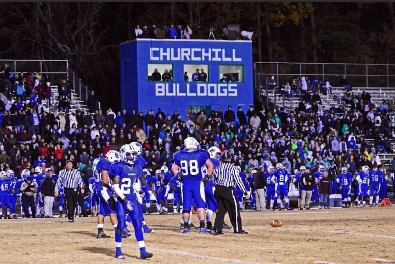 In the front left of the photo, WCHS teacher, coach and alumnus, Ikechukwu Amadi-Davis, stands in the front left corner and played varsity football on the ‘Friday Night Lights’ field 10 years ago. Around him, the crowd is dressed up in blackout outfits to fit the game theme.