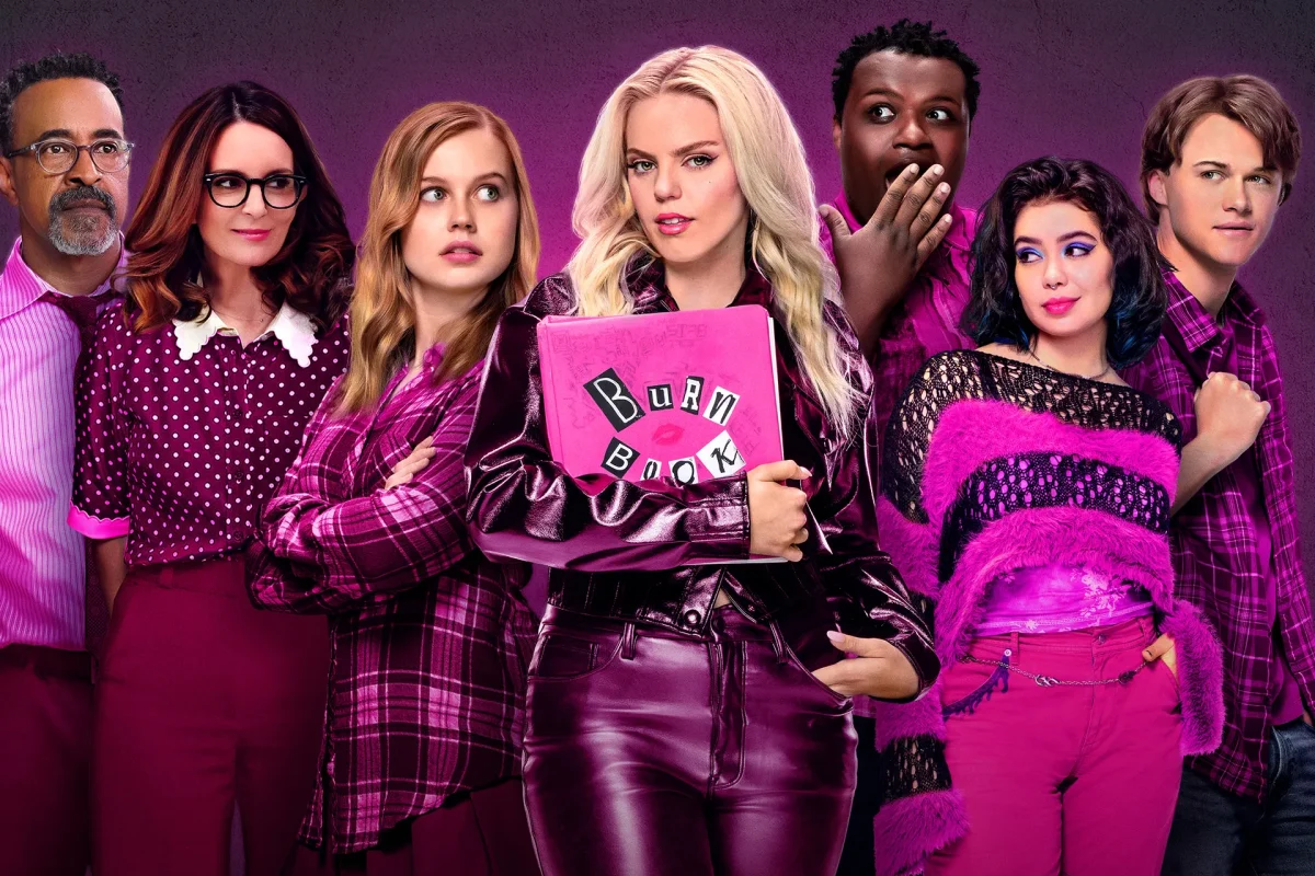 Mean girls heavily revolves around the Burn Book, centered in the middle, which the Plastics use to insult the junior class. Regina (Reneé Rapp), who is also centered, is holding the burn book suggesting there is a lot of the drama revolves around her. 