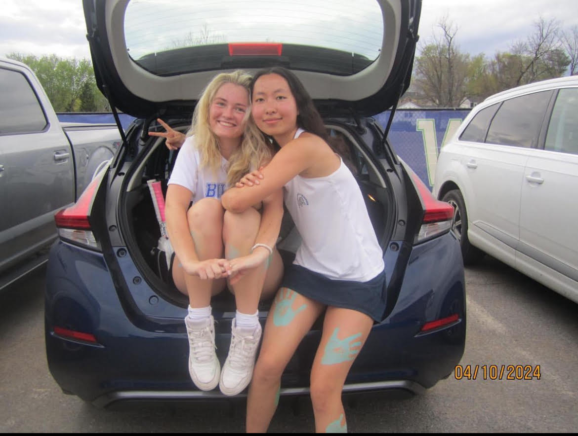 WCHS Girls Tennis Varsity Captain Sasha Stupak, left, and Ingrid Yang, right, smile after a win against Walter Johnson High School.