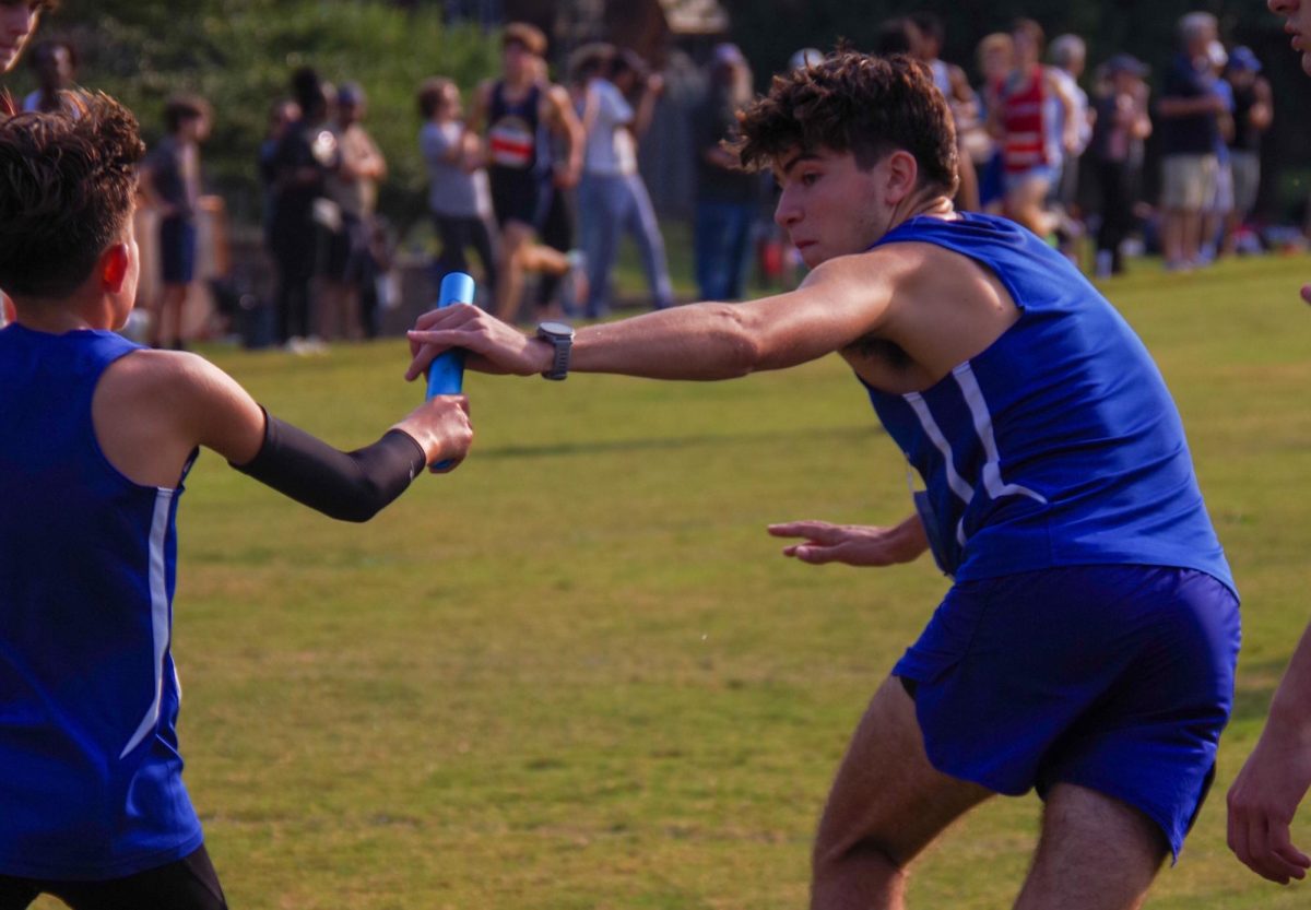 WCHS senior Santiago Gutierrez handed off the baton to WCHS freshman Patricio Pardo at the 52nd annual Woodward Relays at Georgetown Prep in September.