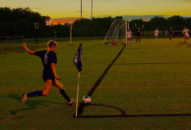 WCHS Senior Laila Foose kicks the soccer ball in from the corner of the field. She is a captain on the WCHS Girls' Soccer team.