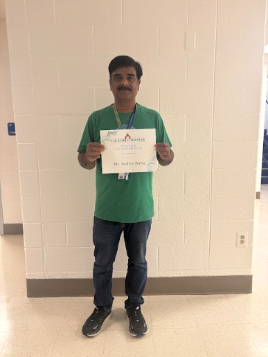 Sudhir Bottu holds up his "Teacher of the Month" certificate. For about three years, Bottu has been teaching autistic students at WCHS. 