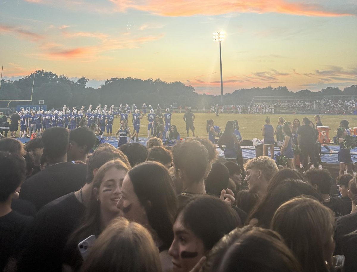 The sun sets over as students watch the Varsity Football team take on Wootton in 2024.