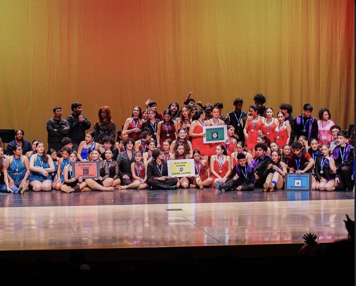 Xplosion Latin dance team (in the bright red) awaiting the award ceremony after dancing at the 2025 Annual Latin Dance Junior Division Competition. The competition was held at Seneca Valley High School.