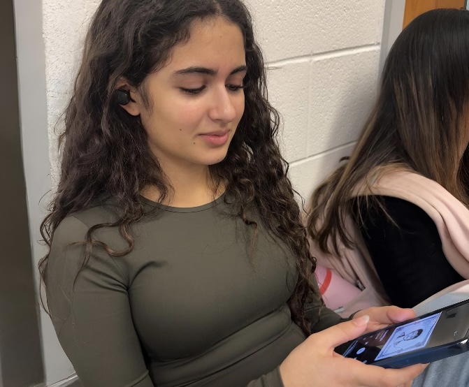 WCHS sophomore Ariana Tavakoli spends the beginning of school lunch listening to Bruno Mars' new single "I Just Might", which is already a #1 hit on numerous charts.
