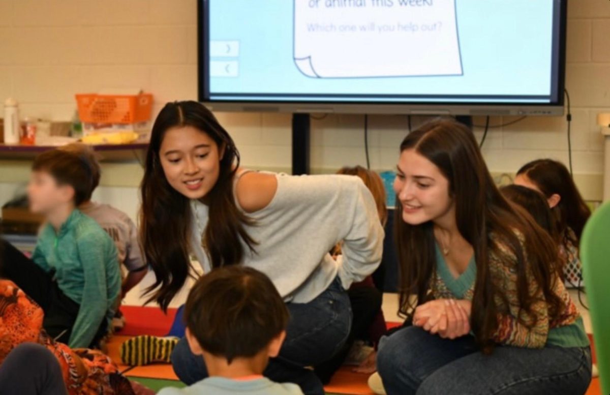 WCHS Juniors Eileen Zhuge (left) and Eden Shaw (right) presenting to second and third graders, helping them develop self-confidence and advocacy skills.