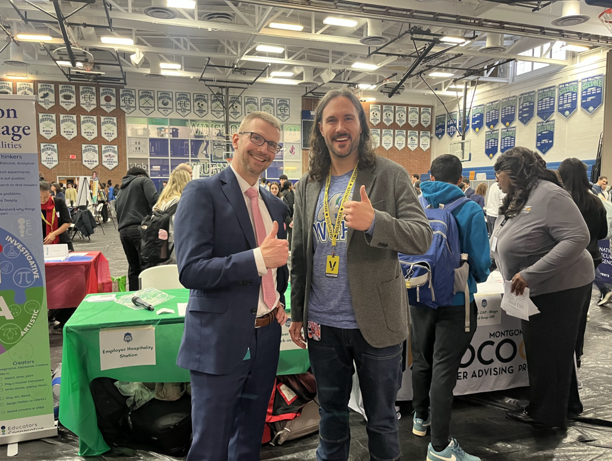 WCHS internship coordinator Mr. Justtin Ostry and WCHS resource teacher Mr. Dylan Antonucci stand at the entrance of WCHS' first-ever career fair with many exciting stalls behind them.